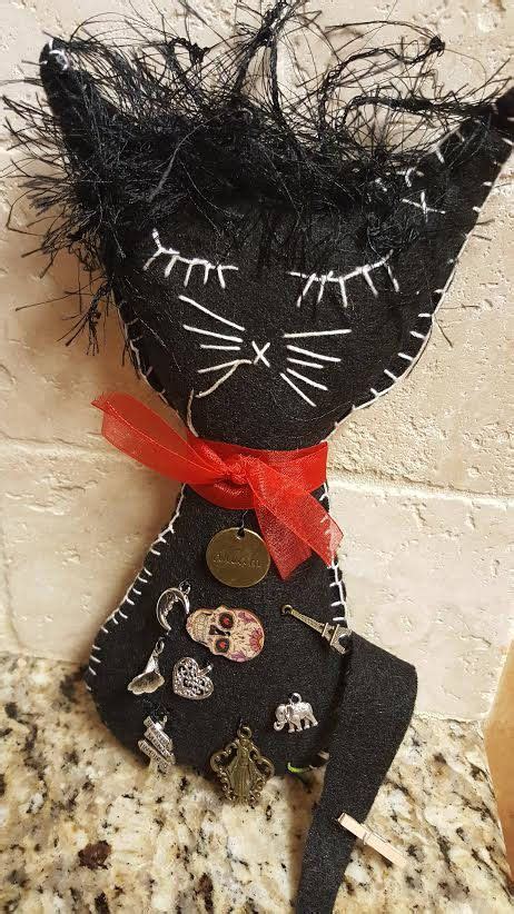 Obsidian hued felines and dolls associated with voodoo traditions